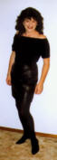 A picture of Kim in leather skirt and shoulders-bared top